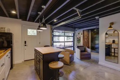 a kitchen with a bar and a living room at Unique Studio on Obanyon Creek in Dtwn Loveland! in Loveland