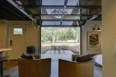 a living room with a table and chairs at Unique Studio on Obanyon Creek in Dtwn Loveland! in Loveland