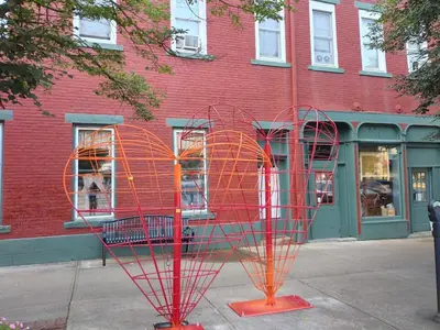 a metal sculpture in front of a red building at The Historic Hideaway in McConnelsville