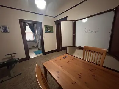 a dining room with a wooden table and chairs at The Historic Hideaway in McConnelsville