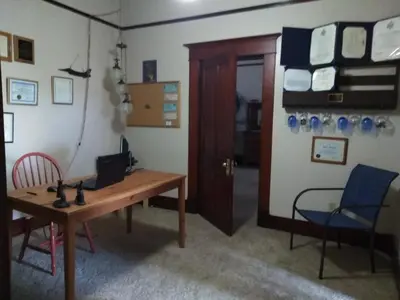 a room with a table and chairs and a door at The Historic Hideaway in McConnelsville
