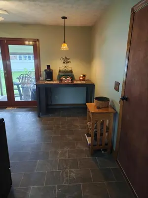 a room with a counter and a table on a floor at Pointer Palace in South Point