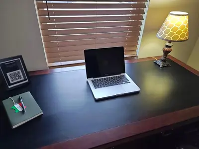 a laptop computer sitting on a desk with a lamp at Pointer Palace in South Point