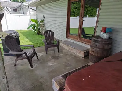 a patio with two chairs and a barrel at Pointer Palace in South Point