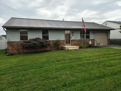 a house with a flag on the front of it at Pointer Palace in South Point
