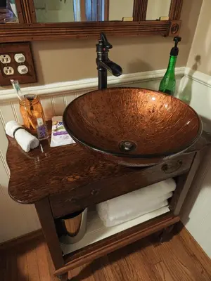 a bathroom sink with a wooden counter top at Pointer Palace in South Point