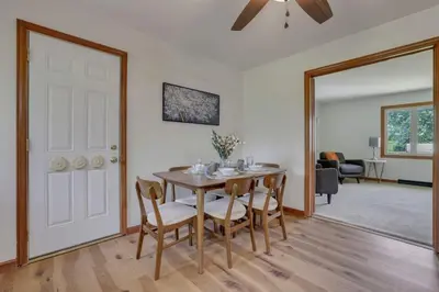 a dining room with a table and chairs and a door at Spacious 4BR Ranch Near Easton Perfect for Families & Work Groups in Columbus