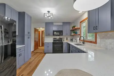 a kitchen with blue cabinets and white counter tops at Spacious 4BR Ranch Near Easton Perfect for Families & Work Groups in Columbus