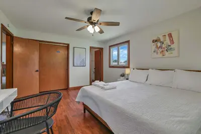 a bedroom with a bed with a ceiling fan at Spacious 4BR Ranch Near Easton Perfect for Families & Work Groups in Columbus