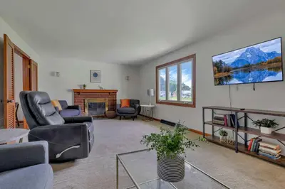 a living room with two chairs and a fireplace at Spacious 4BR Ranch Near Easton Perfect for Families & Work Groups in Columbus
