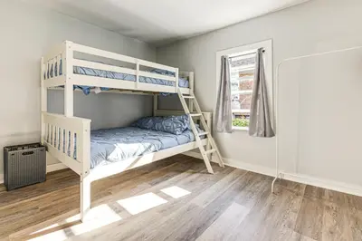 a bedroom with two bunk beds and a window at Walk and Bike Great Miami River Trail Dayton Home in Dayton
