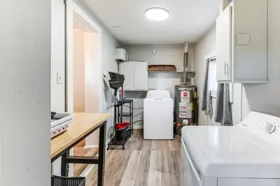 a kitchen with a sink and a refrigerator at Walk and Bike Great Miami River Trail Dayton Home in Dayton