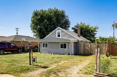 a small house in a yard next to a fence at Walk and Bike Great Miami River Trail Dayton Home in Dayton