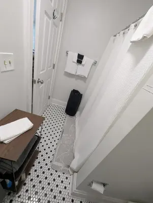 a bathroom with a staircase with a table and towels at Heart of OTR -Stadiums, Museums, Nightlife, Casino in Cincinnati