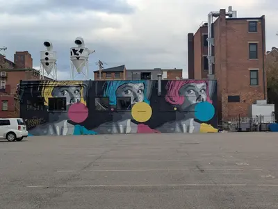 a wall with a painting of dogs on it at Heart of OTR -Stadiums, Museums, Nightlife, Casino in Cincinnati