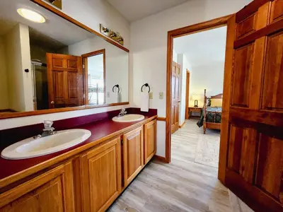 a bathroom with two sinks and a large mirror at Spacious 5 bedroom 16 plus guests on 14 acres with fishing pond in Lagrange