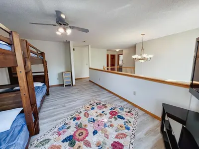a room with two bunk beds and a rug at Spacious 5 bedroom 16 plus guests on 14 acres with fishing pond in Lagrange