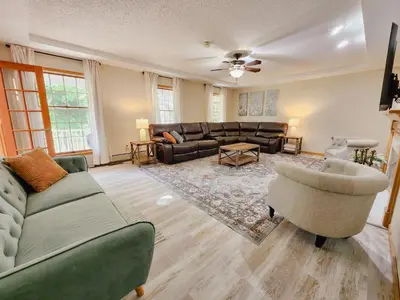 a living room with a couch and a chair at Spacious 5 bedroom 16 plus guests on 14 acres with fishing pond in Lagrange
