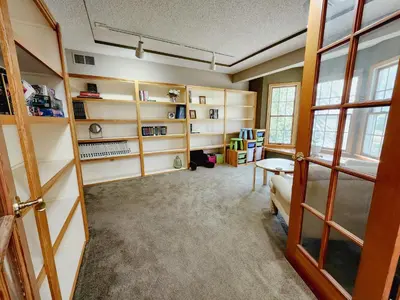 a living room with shelves and a couch in a room at Spacious 5 bedroom 16 plus guests on 14 acres with fishing pond in Lagrange