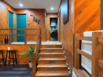 a staircase in a house with wooden walls at Secluded, Luxuriously Remodeled, Gaming, Hot Tub! in South Bloomingville