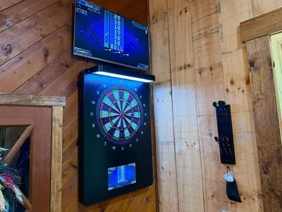 a dart board on a wall with two monitors at Secluded, Luxuriously Remodeled, Gaming, Hot Tub! in South Bloomingville