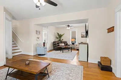 a living room with a table and a couch at Double Game Rooms! - 4BR Only 7 Min to Ark in Williamstown