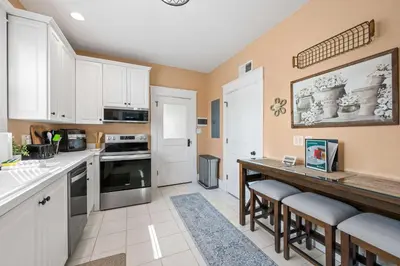 a kitchen with white cabinets and a counter top at Double Game Rooms! - 4BR Only 7 Min to Ark in Williamstown
