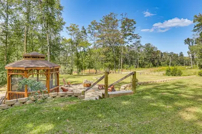 a gazebo in the middle of a field at Charming Couples Cabin on 40 Acres in Zanesville in Zanesville