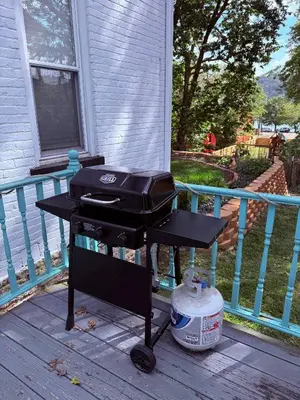 a grill sitting on a deck on a porch at The Riverstone Getaway in historical Madison, IN in Madison