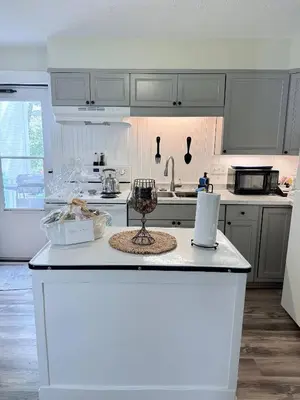 a kitchen with white cabinets and a white counter top at The Riverstone Getaway in historical Madison, IN in Madison