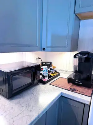 a microwave oven sitting on a kitchen counter at The Riverstone Getaway in historical Madison, IN in Madison