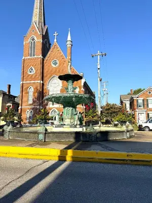 a church with a fountain in front of a church at The Riverstone Getaway in historical Madison, IN in Madison
