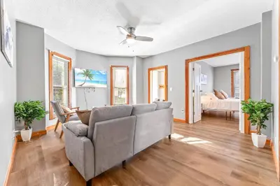 a living room with a couch and a bed at Main Floor Tremont Home with KING Bed, Mins From DT, Pet Friendly in Cleveland