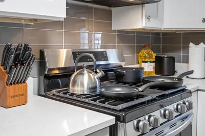 a kitchen with a stove with pots and pans on it at Main Floor Tremont Home with KING Bed, Mins From DT, Pet Friendly in Cleveland