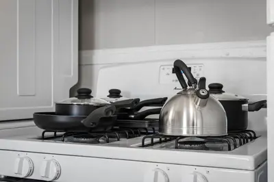 a tea kettle sitting on top of a stove at Group Suite in Tremont, 4 TV's, Pet Friendly in Cleveland