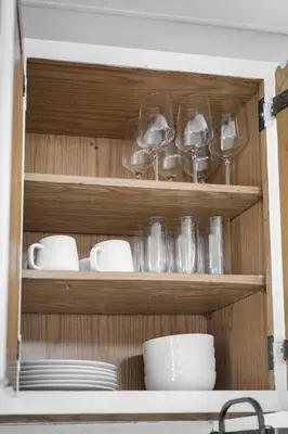 a cupboard filled with dishes and glasses and plates at Group Suite in Tremont, 4 TV's, Pet Friendly in Cleveland