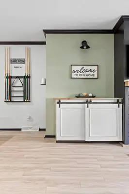 a kitchen with white cabinets in a room at Luxe Suite with Pool Table, King Bed, 3 TVs, & Free Parking in Cleveland