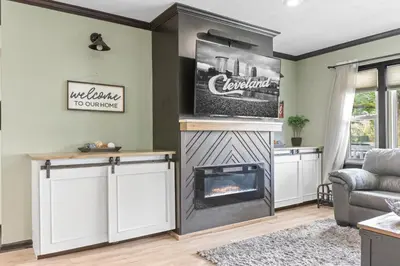 a living room with a fireplace and a couch at Luxe Suite with Pool Table, King Bed, 3 TVs, & Free Parking in Cleveland