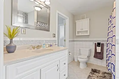 a bathroom with a sink and a toilet at Ohio City 4 Bed 3 TV Free Parking Mins to DT in Cleveland