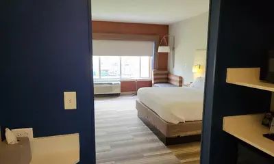 a hotel room with a bed and a window at Holiday Inn Express & Suites Toledo South - Perrysburg by IHG in Perrysburg Heights