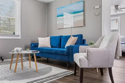 a living room with a blue couch and a chair at KING Bed Entire House Near DT in Cleveland