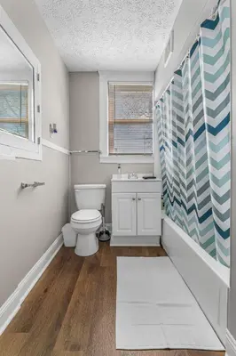 a bathroom with a toilet and a sink and a window at Luxe Mattresses Pet Friendly Free Prkng WiFi in Cleveland