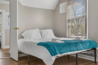 a bedroom with a bed with a blue blanket on it at Luxe Mattresses Pet Friendly Free Prkng WiFi in Cleveland