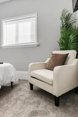 a white couch sitting in a room with a window at Little Italy Family Suite 4 TVs Bunk Beds in Cleveland