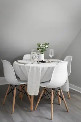 a dining room table with white chairs and a white table cloth at King Bed 2 TVs Fast Wifi Pet Friendly! in Cleveland