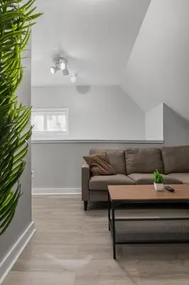 a living room with a couch and a table at King Bed 2 TVs Fast Wifi Pet Friendly! in Cleveland