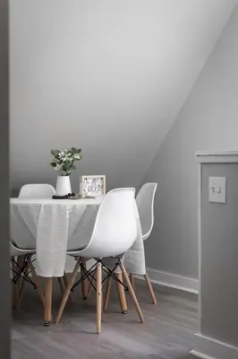 a dining room table with white chairs and a vase of flowers at King Bed 2 TVs Fast Wifi Pet Friendly! in Cleveland