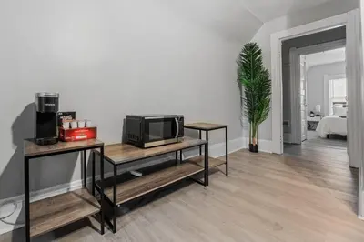 a living room with a tv on a table at King Bed 2 TVs Fast Wifi Pet Friendly! in Cleveland