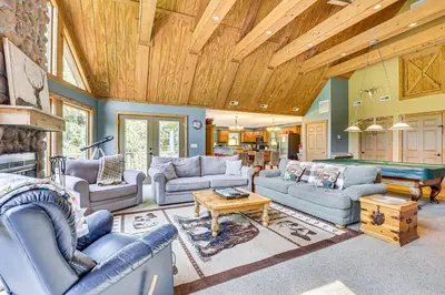 a living room with couches and a pool table at 23 Mi to Mohican SP Group-Ready Lodge with Hot Tub in Brinkhaven