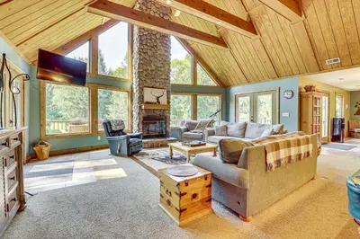 a living room with a couch and a fireplace at 23 Mi to Mohican SP Group-Ready Lodge with Hot Tub in Brinkhaven